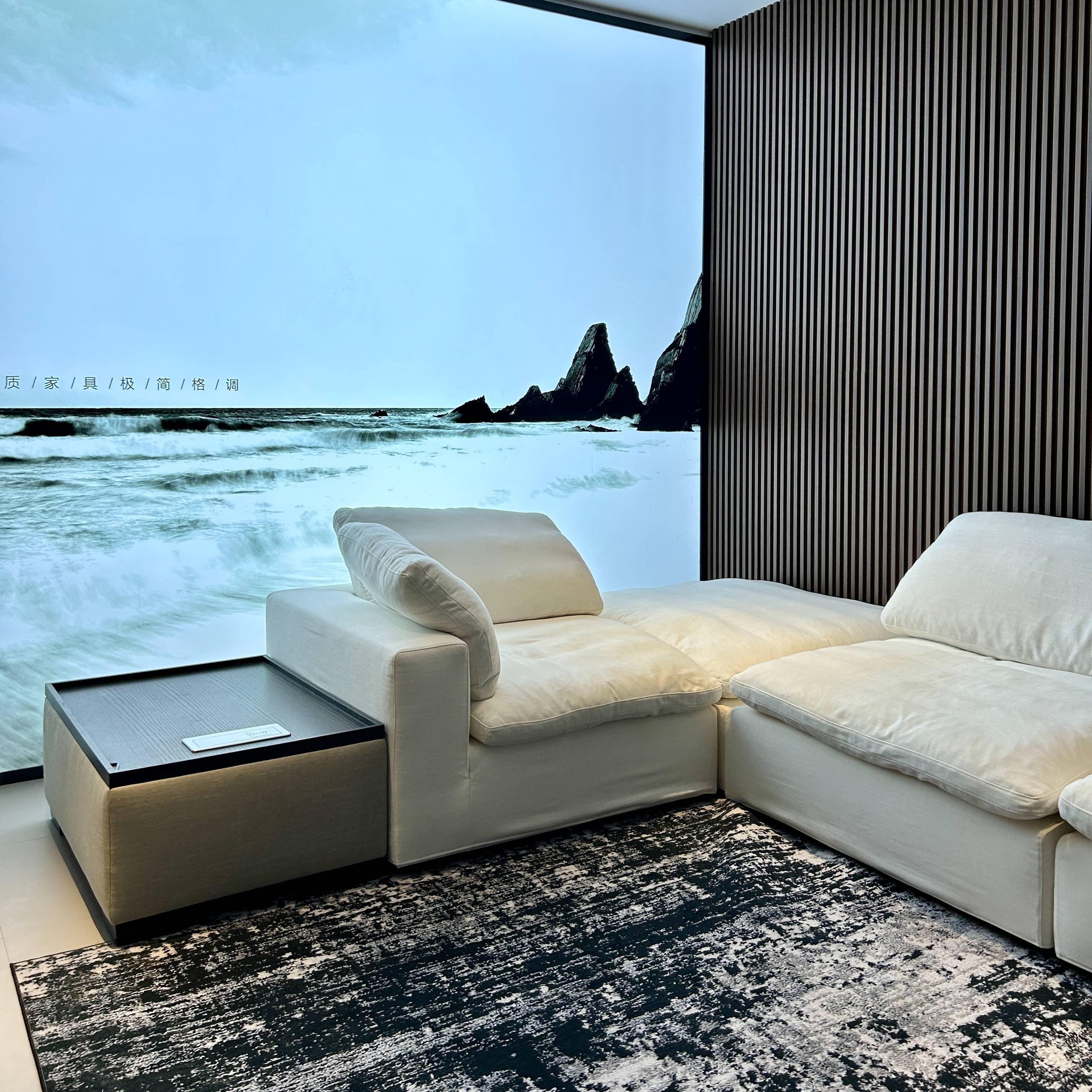 Side view of the sofa with a side table and ocean backdrop