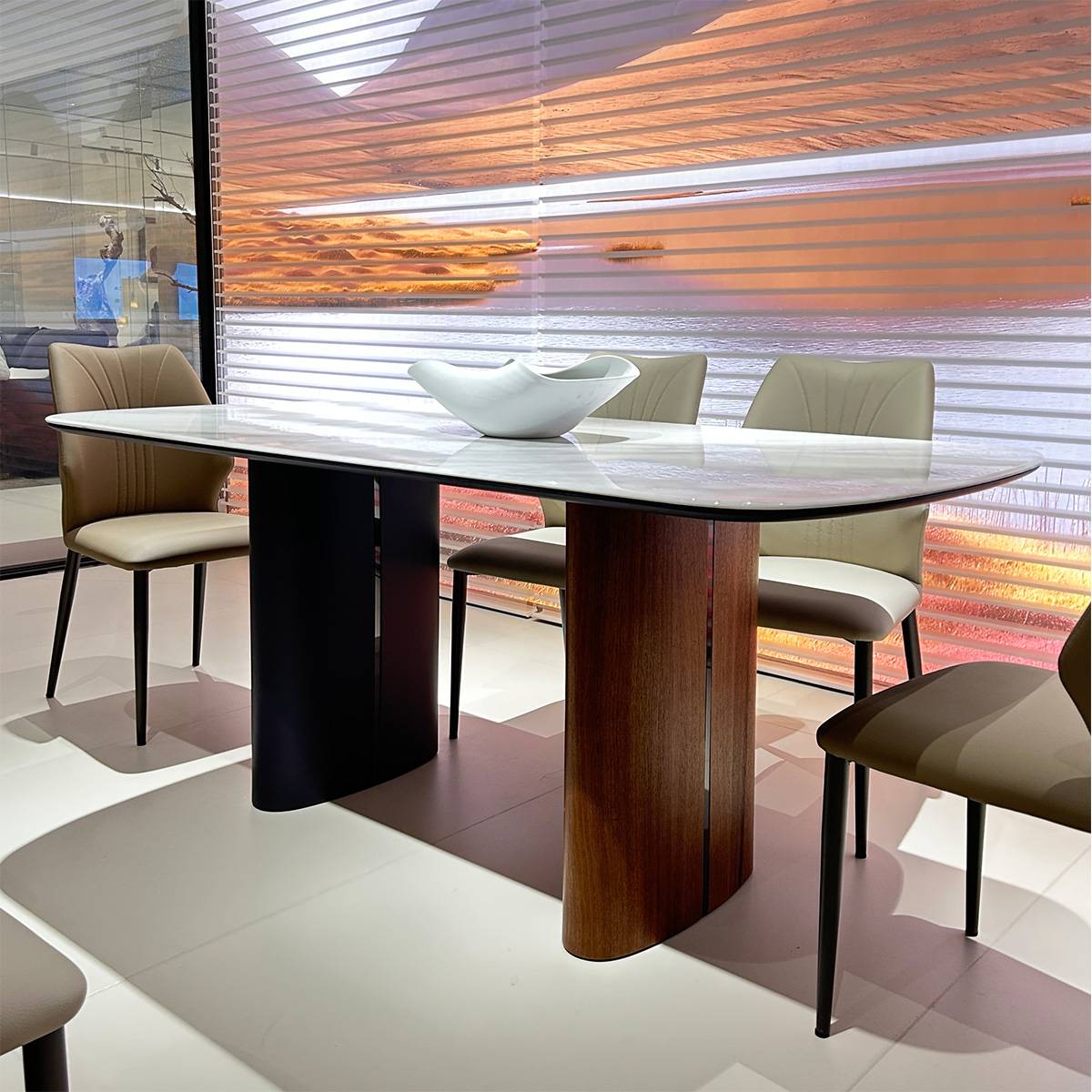 Side angle view of the dining table showing the walnut and black base