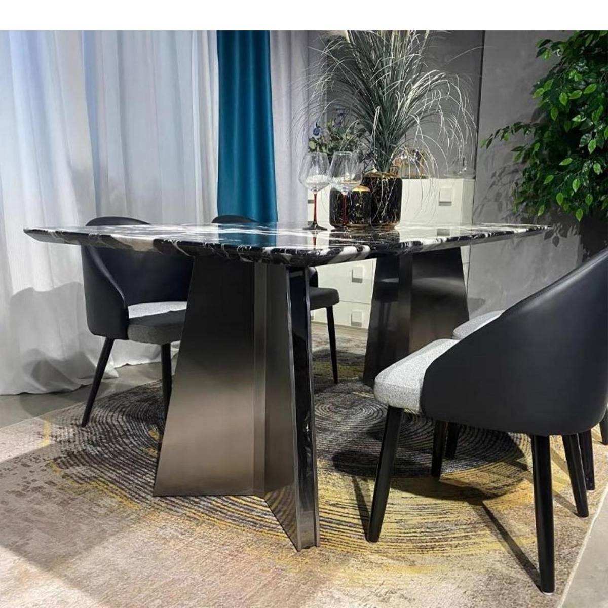Side view of the dining table highlighting the stainless steel base and marble edge