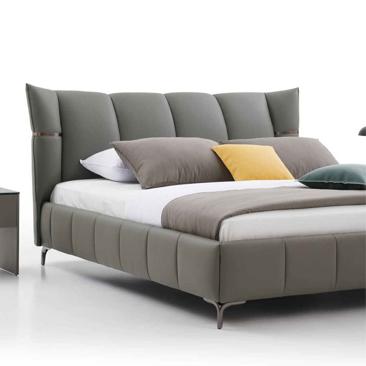 Close-up angled view of the bed headboard and bedding