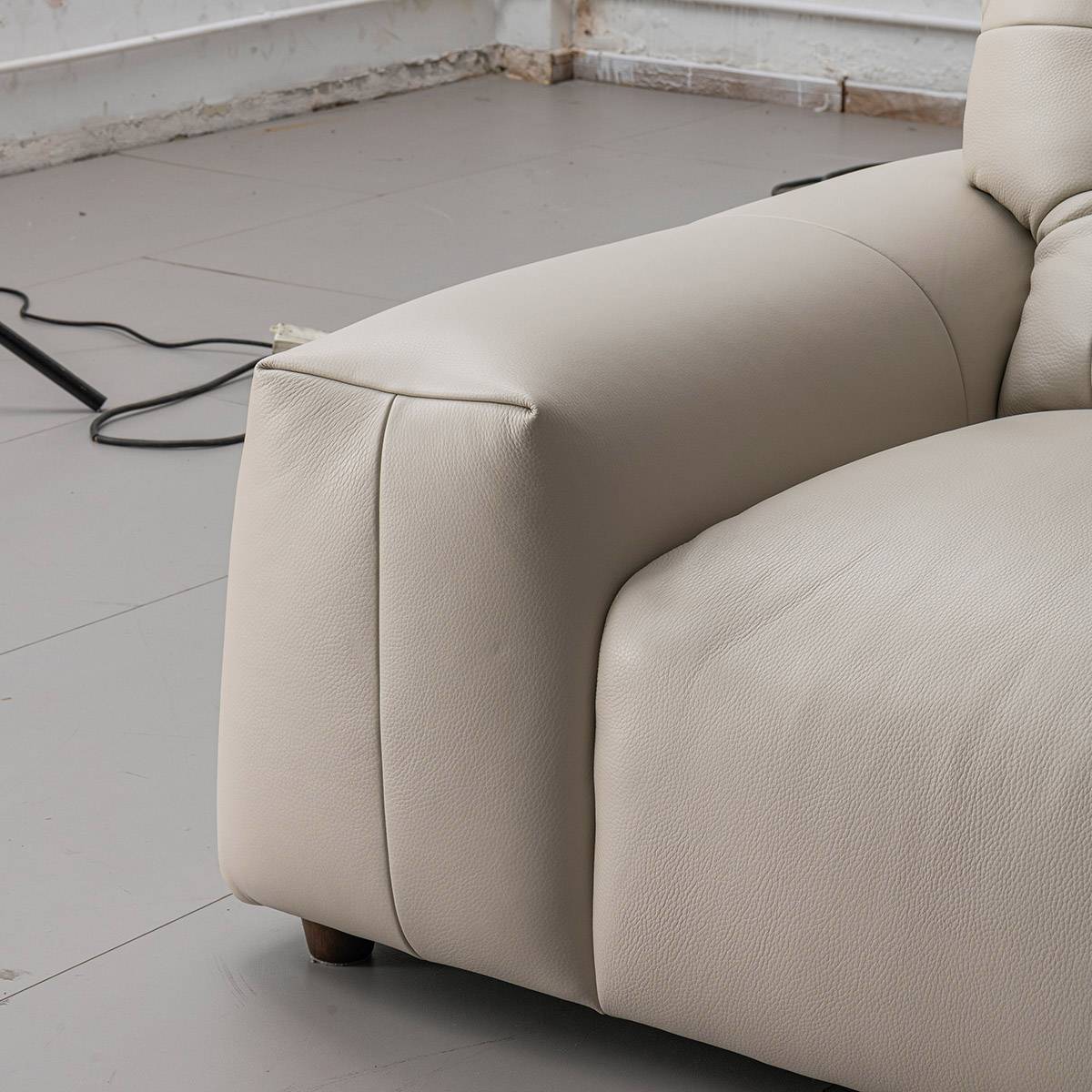 Close-up detail of the sofa armrest and leather texture