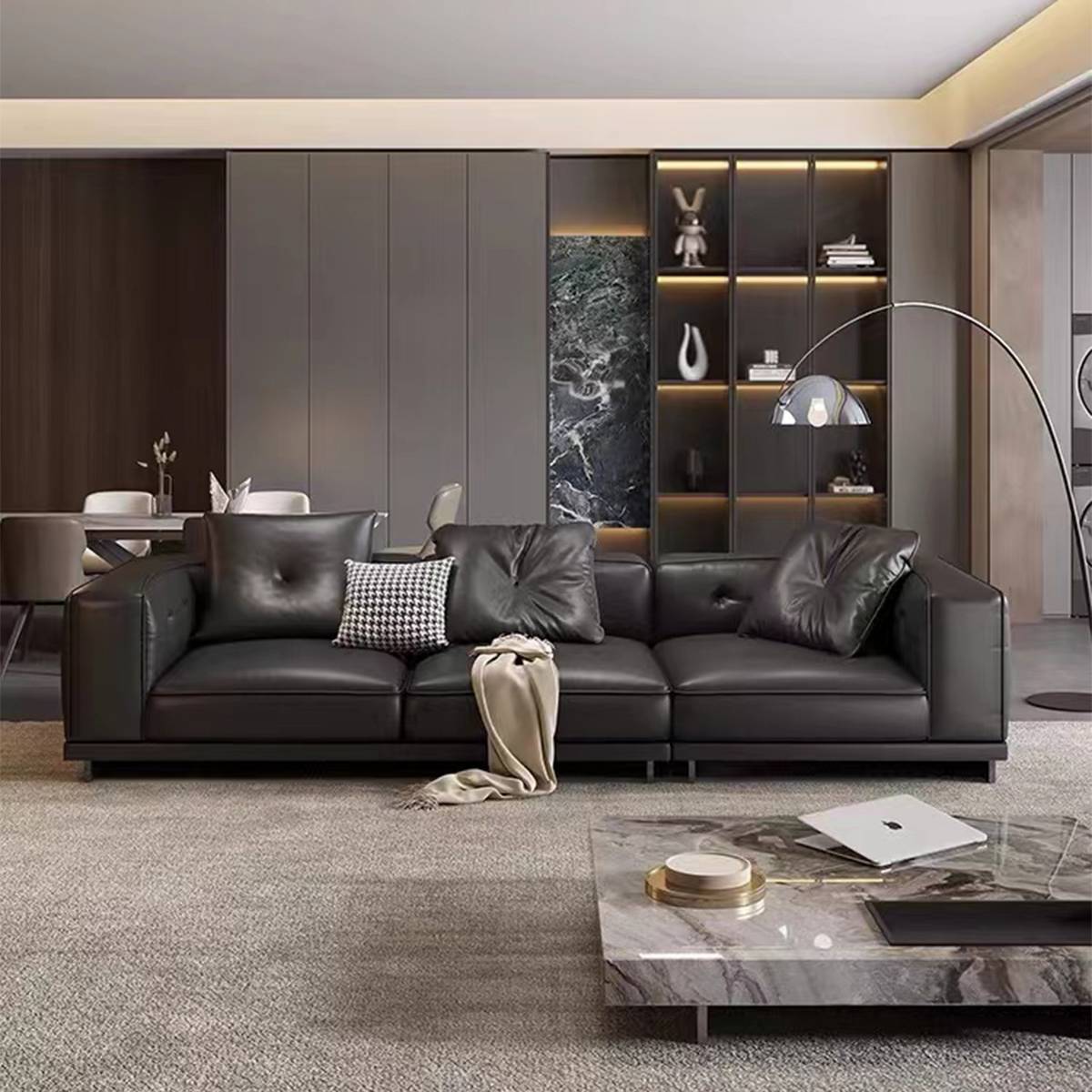 Front view of black leather straight sofa with marble coffee table