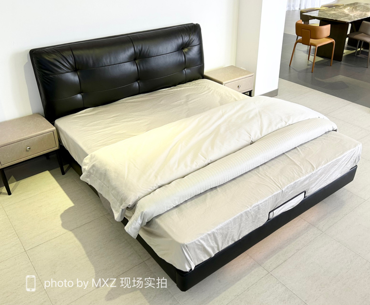 Full view of the bed with white bedding and bedside tables
