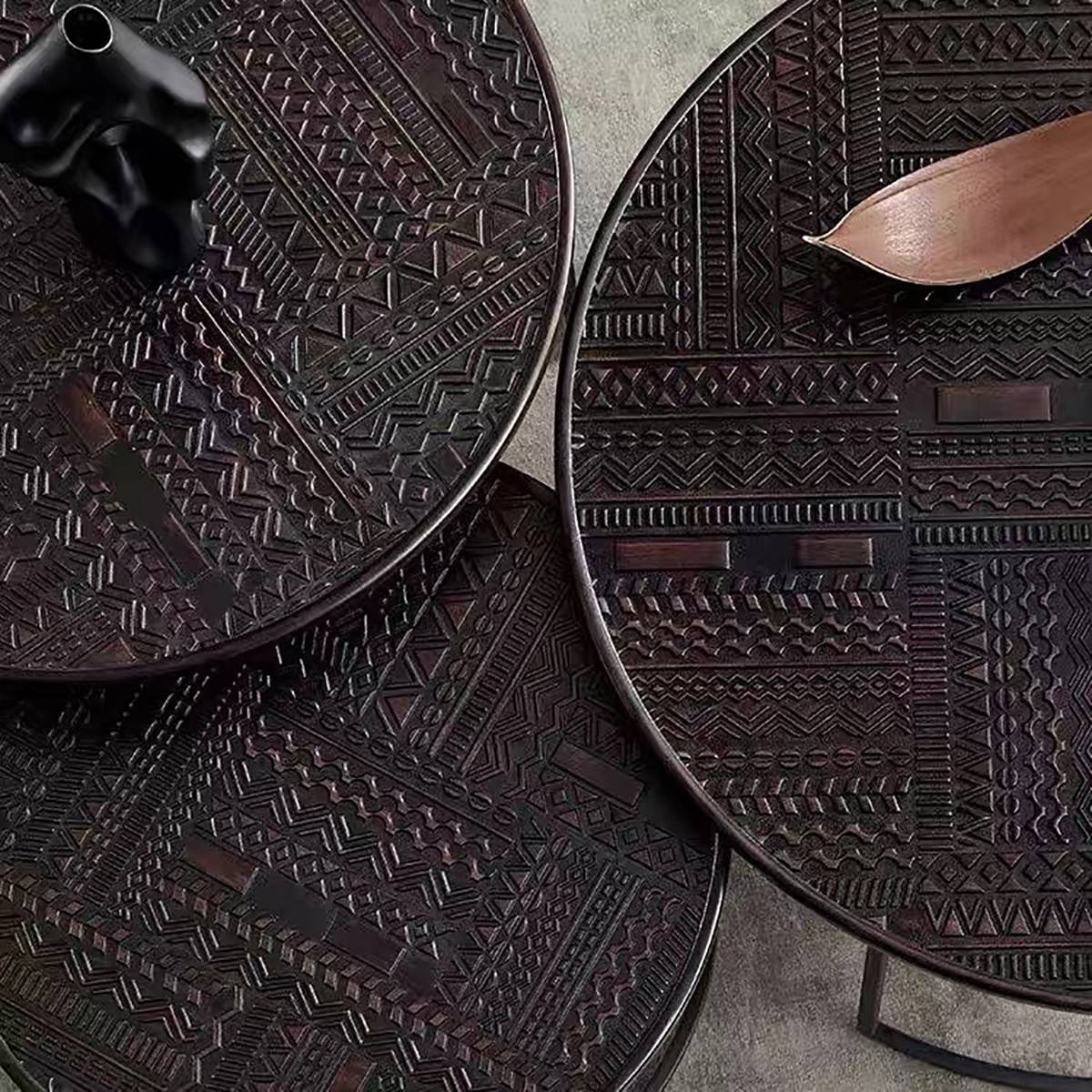 Close-up detail of the geometric embossed pattern on the table tops