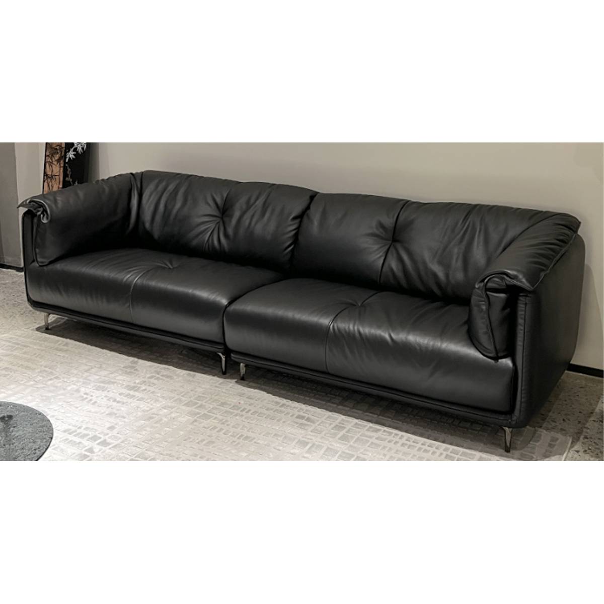 Black leather sofa in living room setting