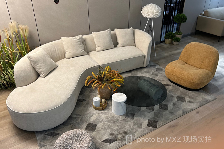 Beige curved moon sofa in a modern living room setup