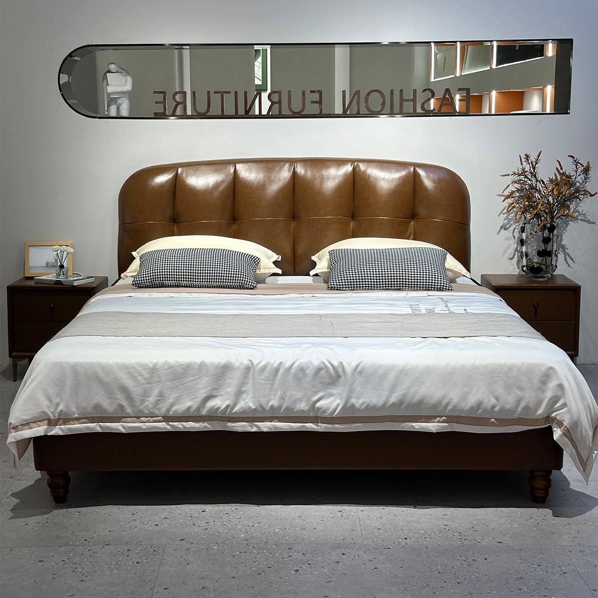 Front view of the bed with white bedding and checkered pillows