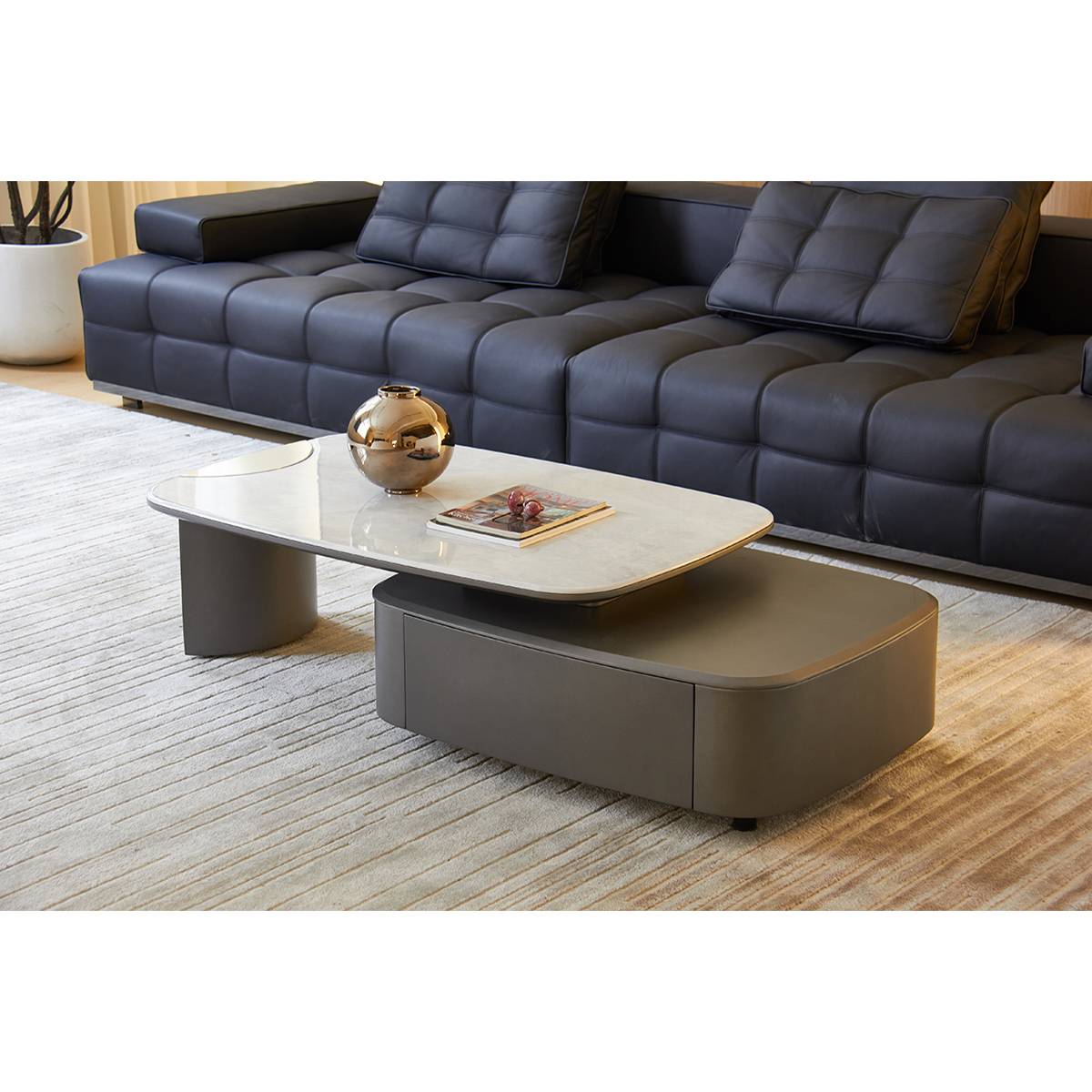 Side view of the coffee table in a living room setting with a grey sofa.