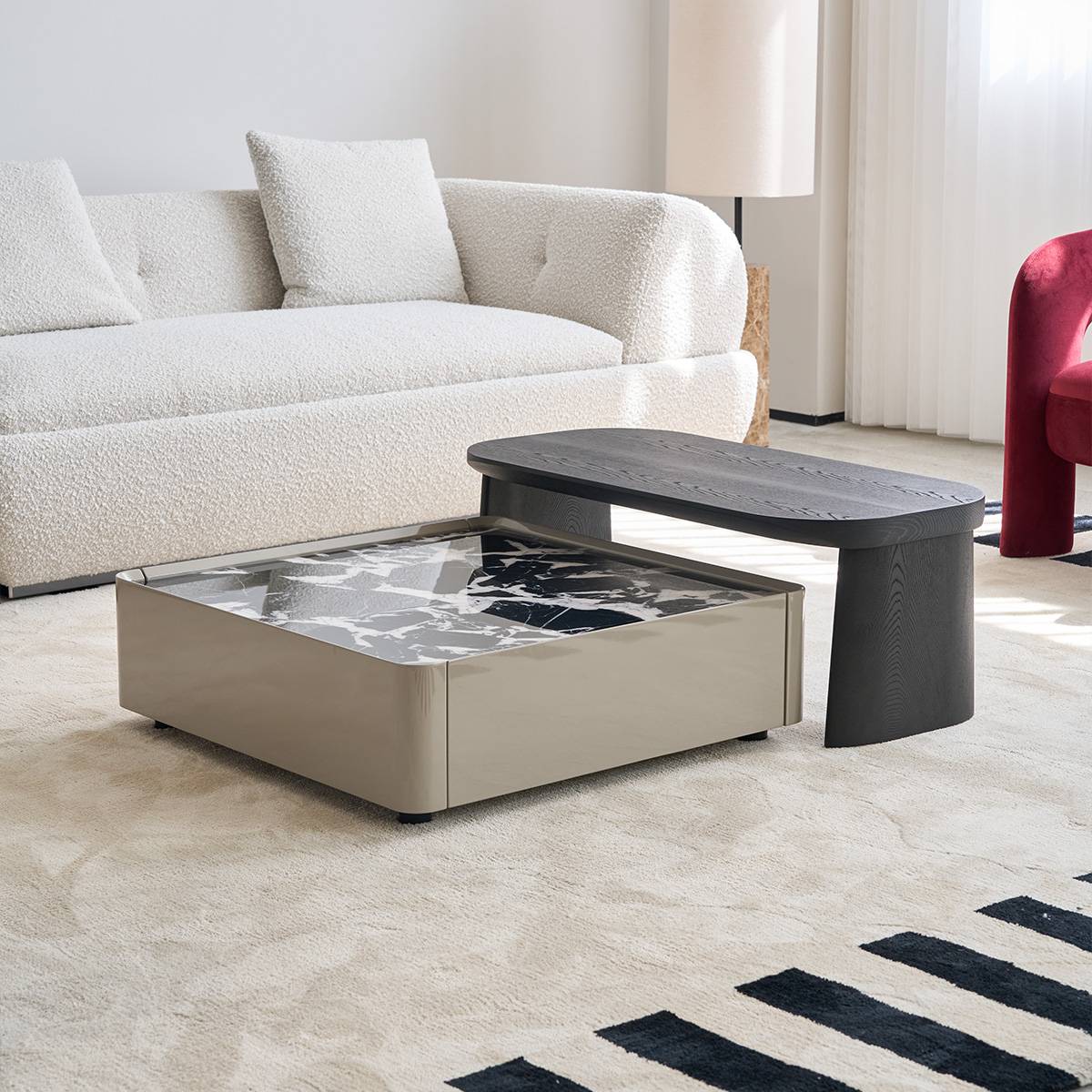 Side angle view of the nesting coffee table set showing the metallic base and stone top.