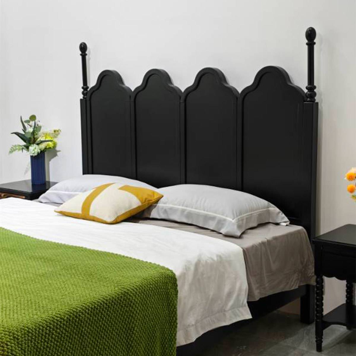 Side angle view of black mid-century bed showing turned posts and headboard detail