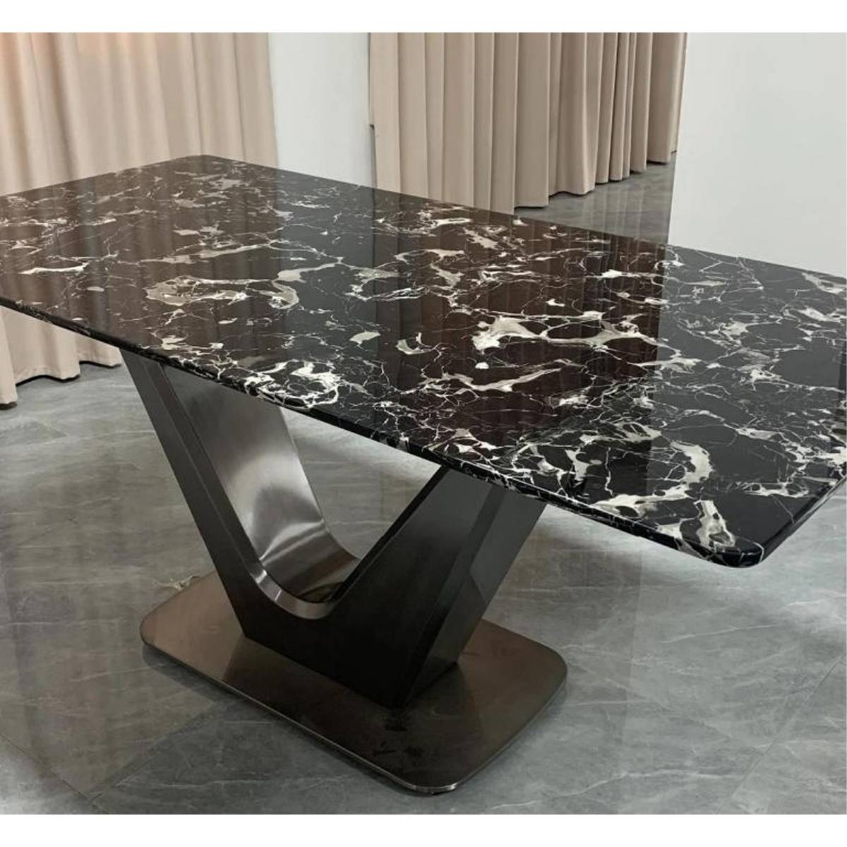 Close-up view of the Black Rose marble tabletop and stainless steel V-base