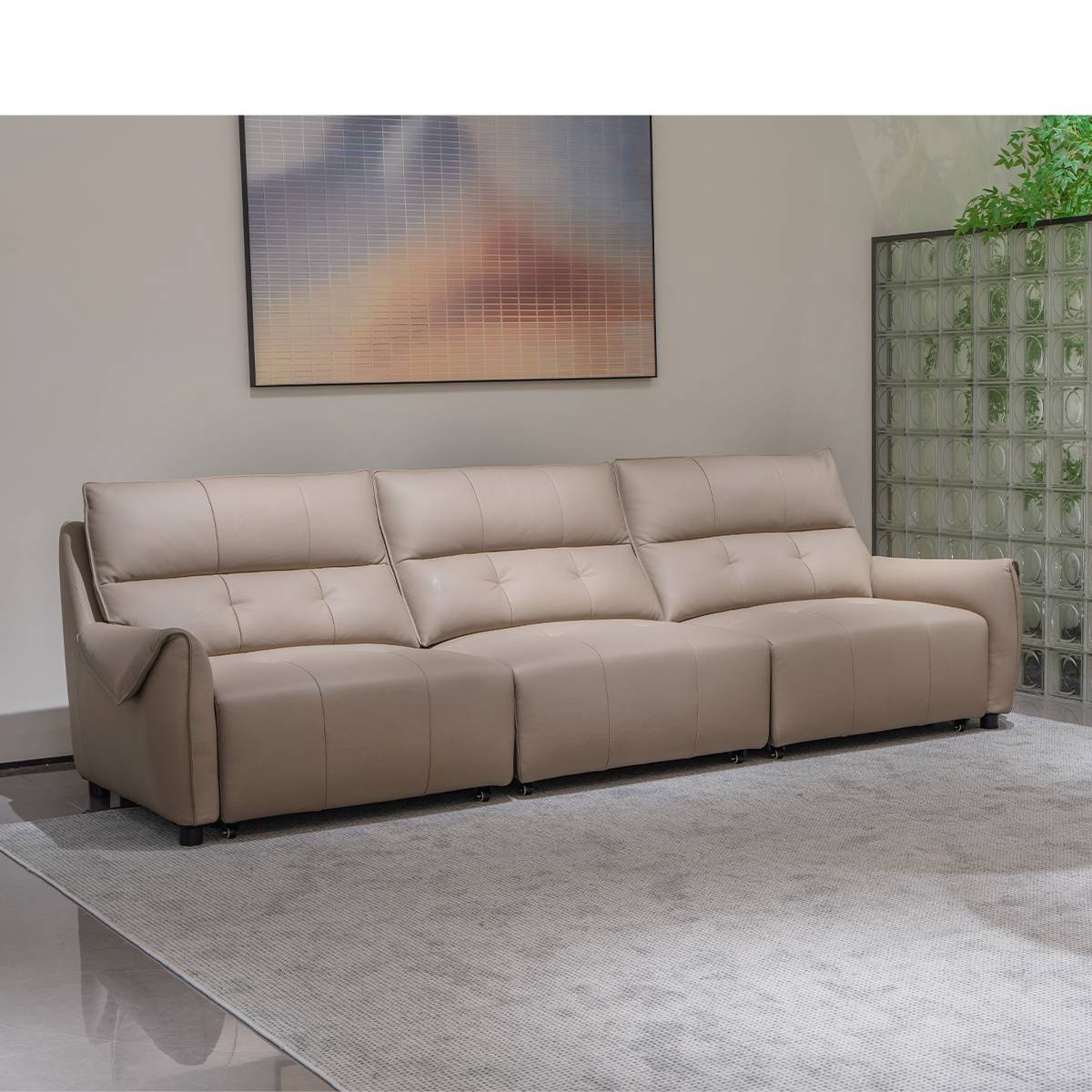 Side view of the beige leather sofa showing reclining mechanism and solid wood frame