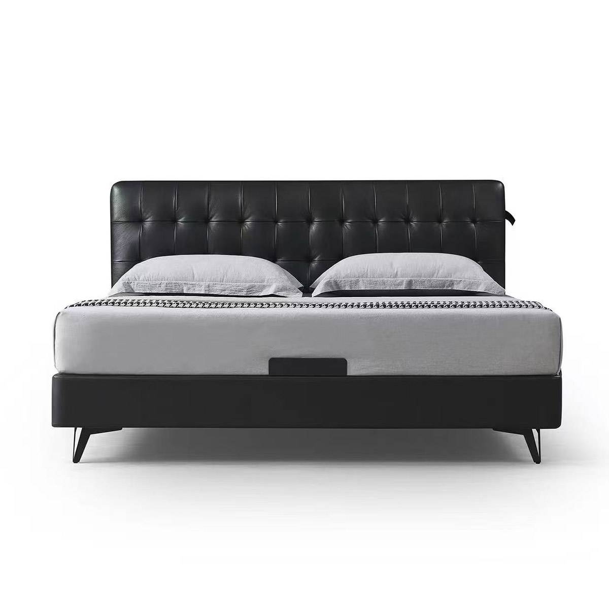 Front view of black tufted leather bed with grey mattress and pillows