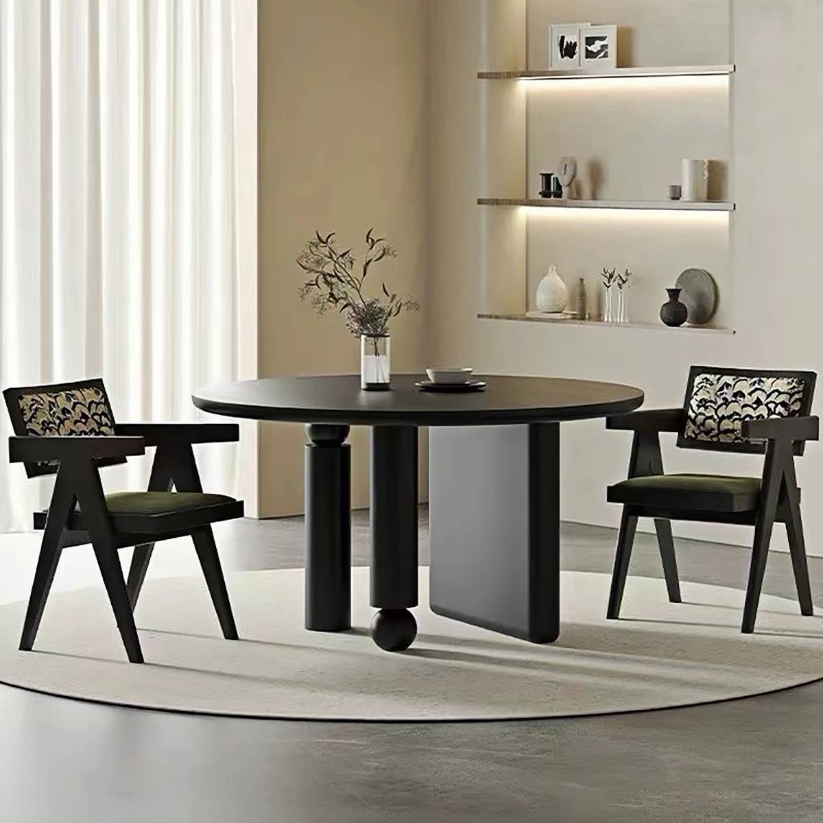 Dining room setup with two chairs and a round black table