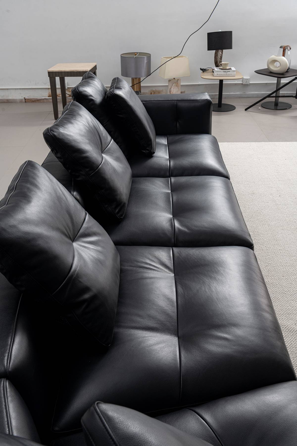 Close-up view of black leather sofa cushions and texture