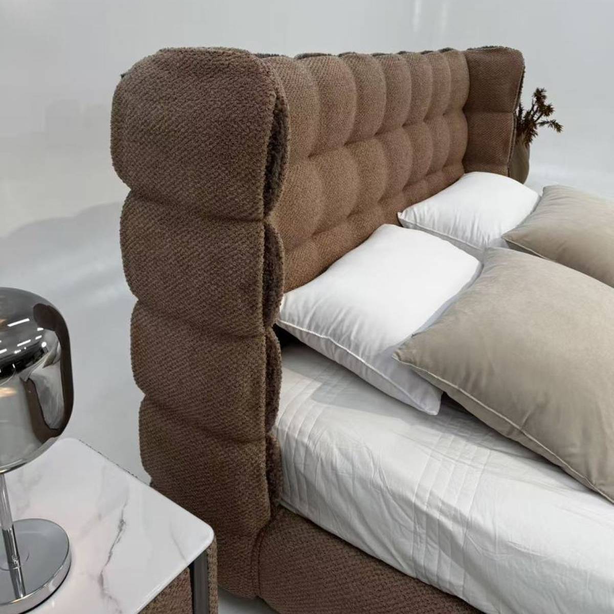 Detail shot of the tufted wingback headboard texture and side profile