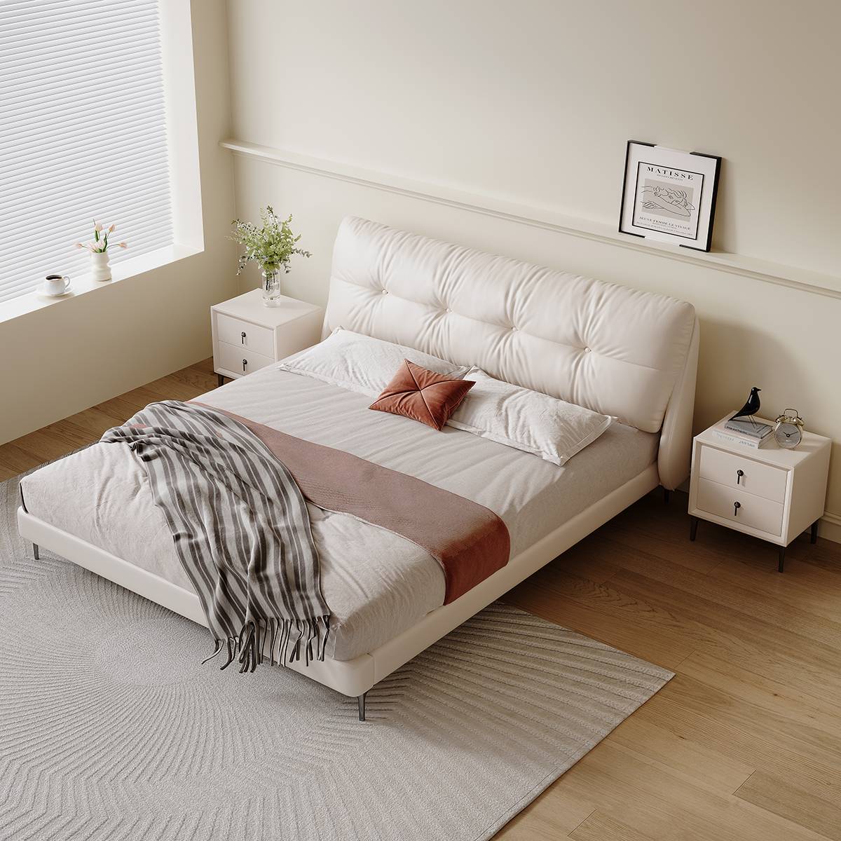 White upholstered bed with bedding and throw blanket