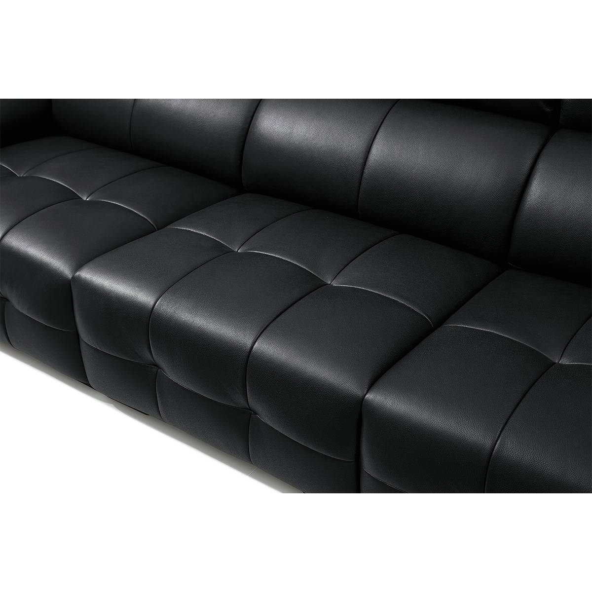 Close-up detail of black leather sofa upholstery showing tufted texture
