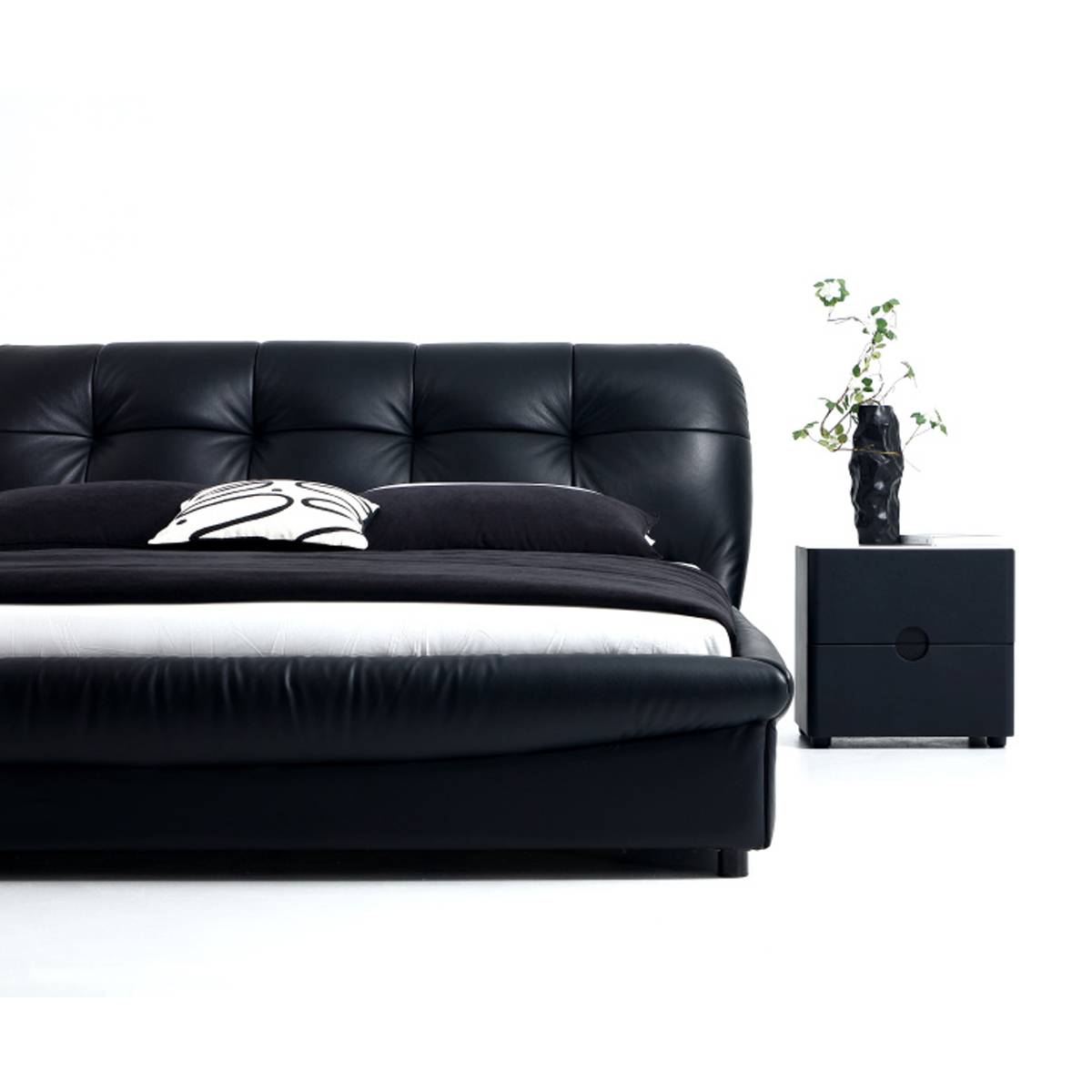 Close-up detail of the tufted leather headboard and footboard