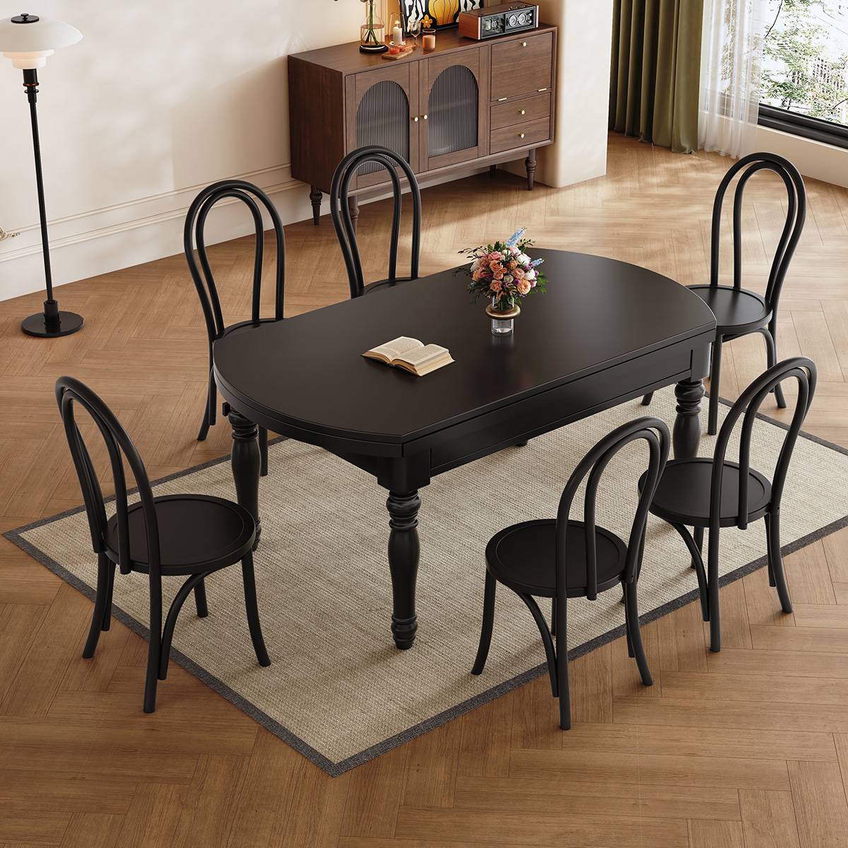 Black mid-century dining table in extended rectangular configuration with six chairs