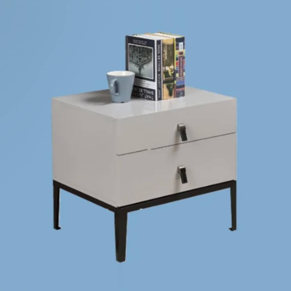 Angled view of the bedside table with books and a mug on top