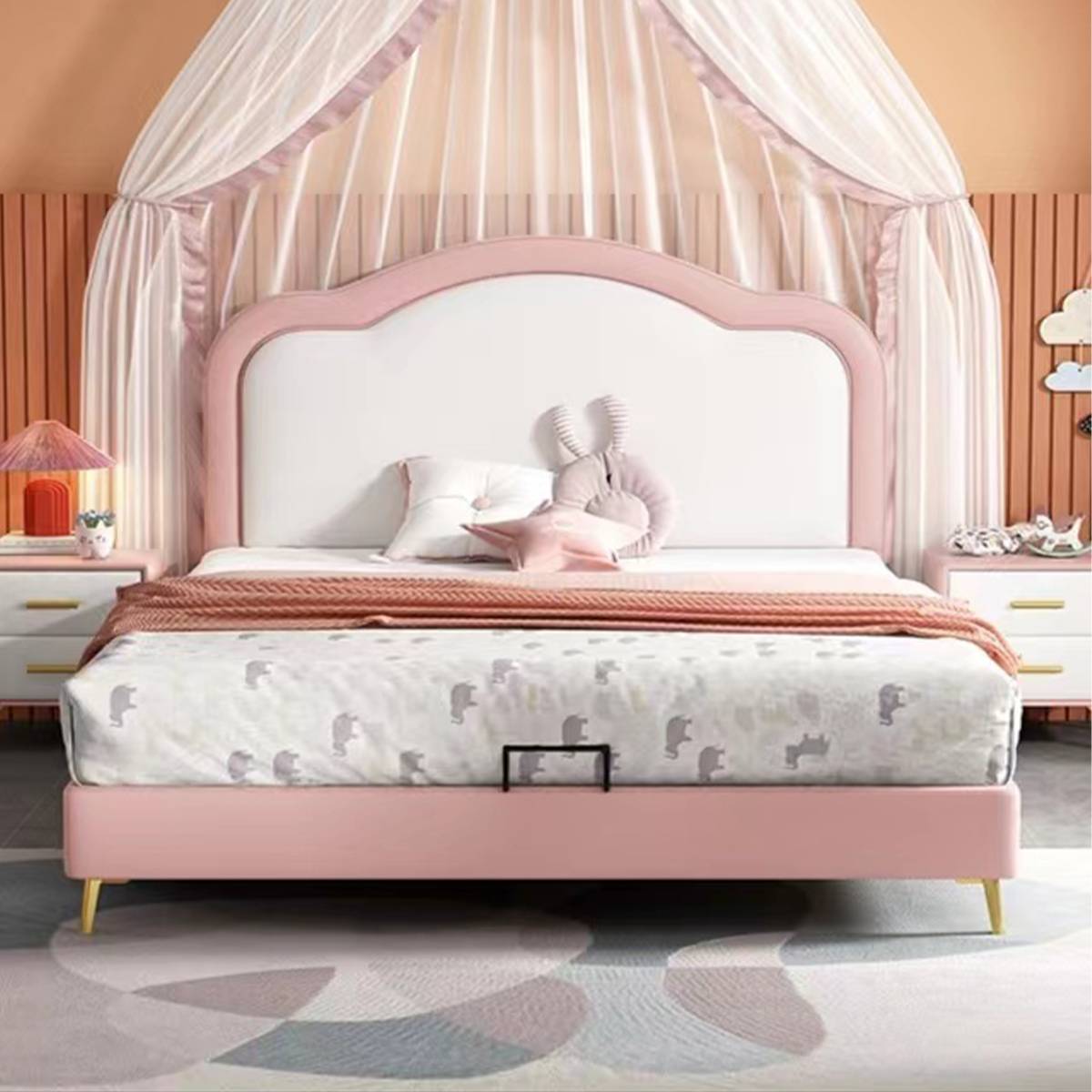 Front view of the pink and white upholstered bed with canopy