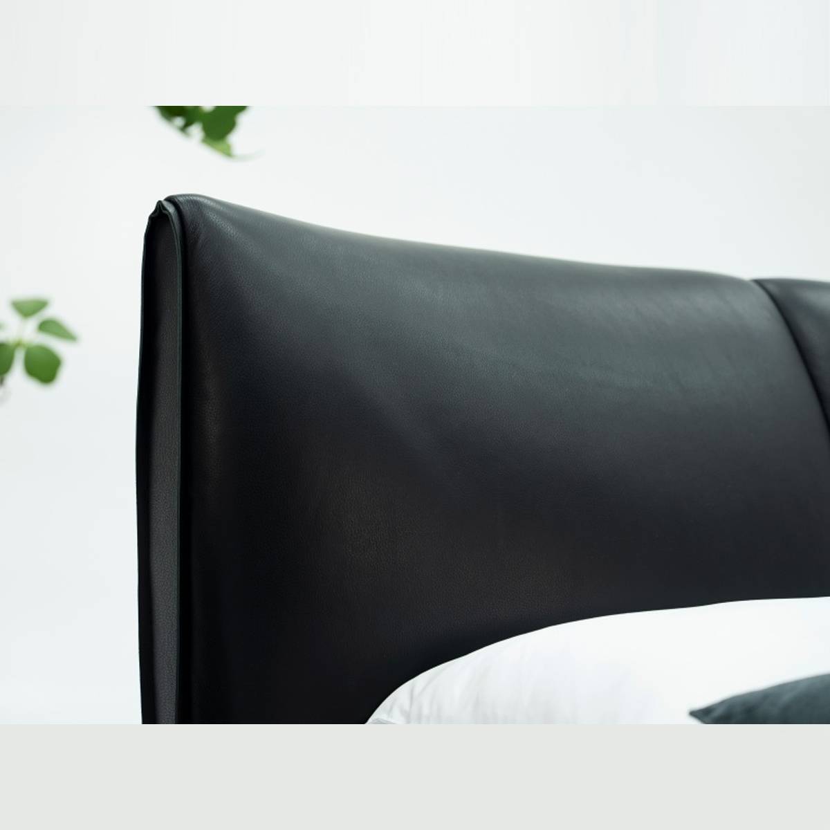 Close-up detail of the black leather headboard texture