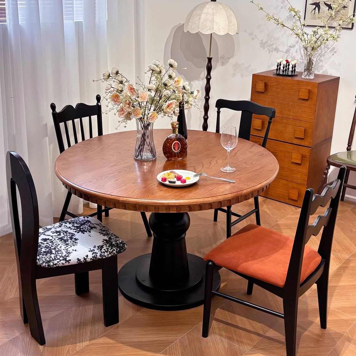 Walnut finish round dining table with mixed style chairs