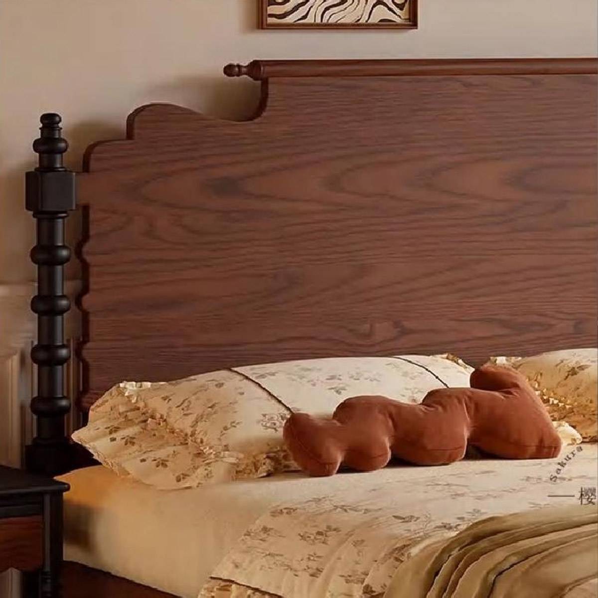 Close-up detail of the wooden headboard and black turned post