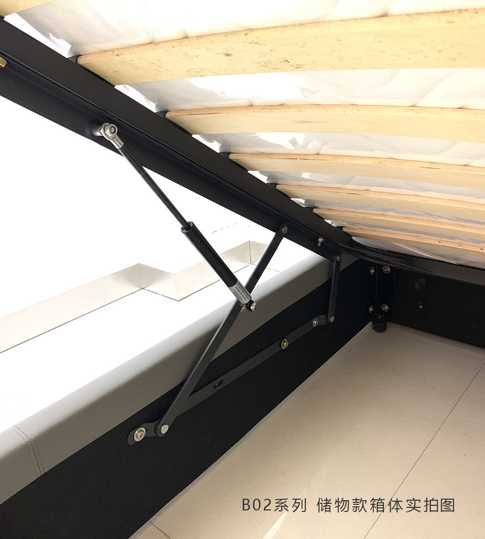 Close-up detail of the black metal hydraulic gas lift mechanism and wooden slats.