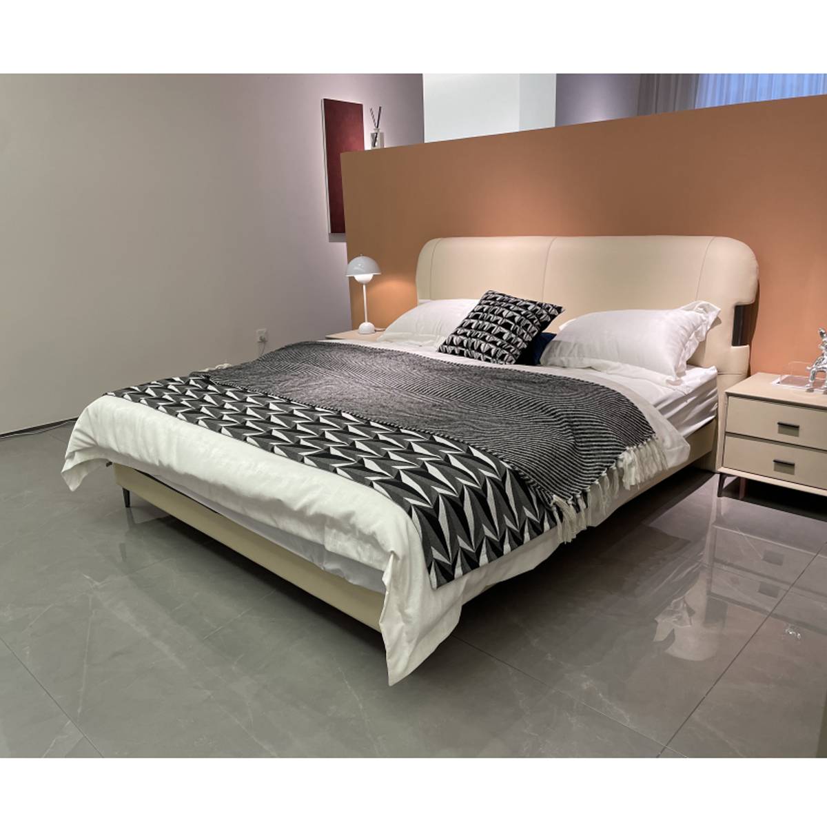Angled view of the bed showing the bedding and headboard design