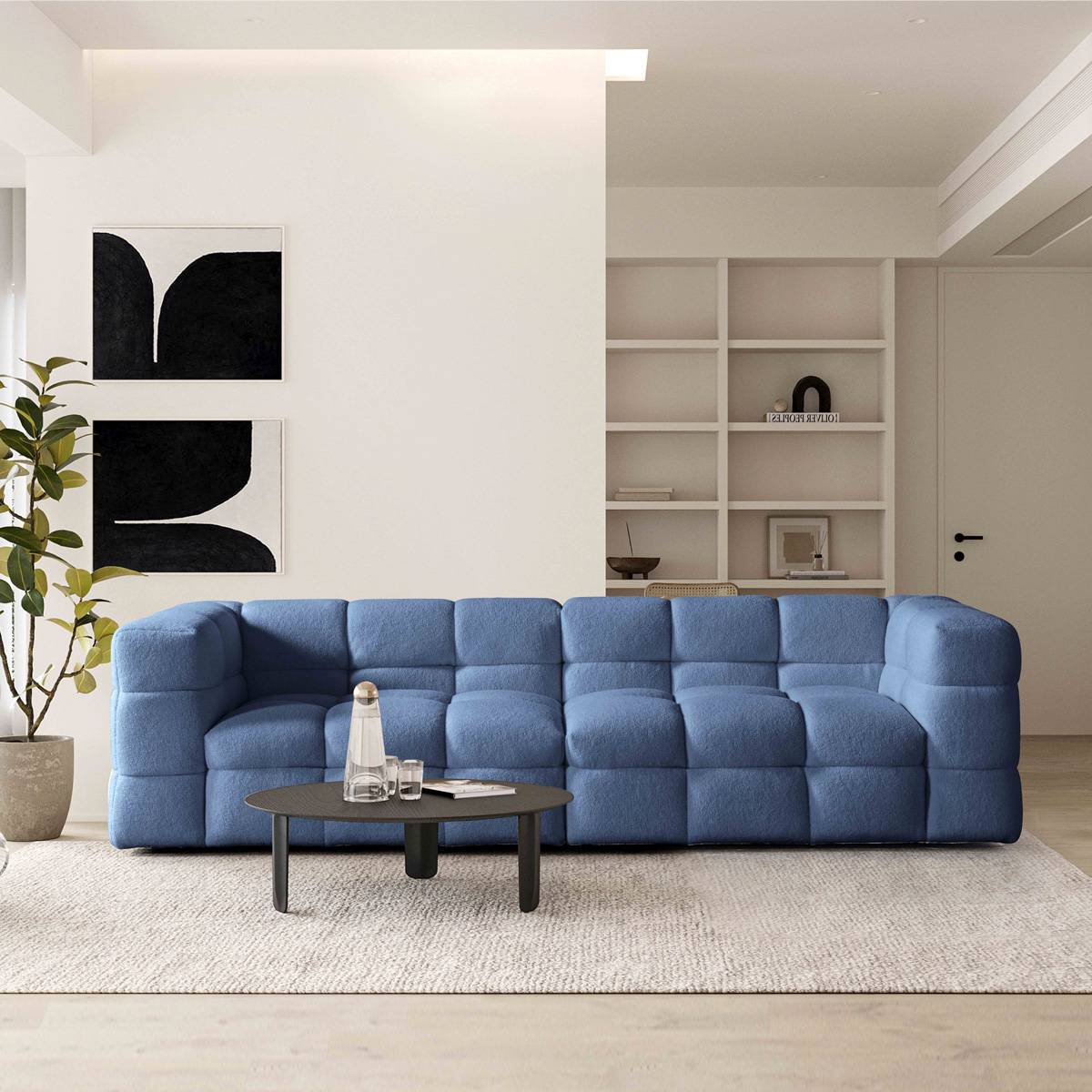 Blue tufted marshmallow sofa in a modern living room setting