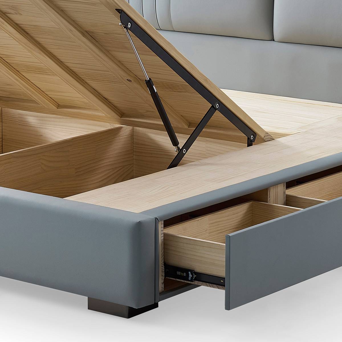 Full view of the grey upholstered bed with the high-box storage lid open and drawers pulled out