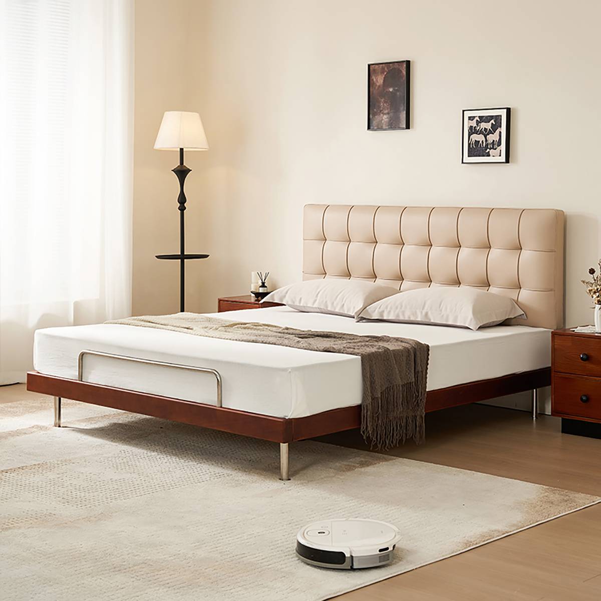 Beige waffle tufted bed with walnut frame and robot vacuum nearby