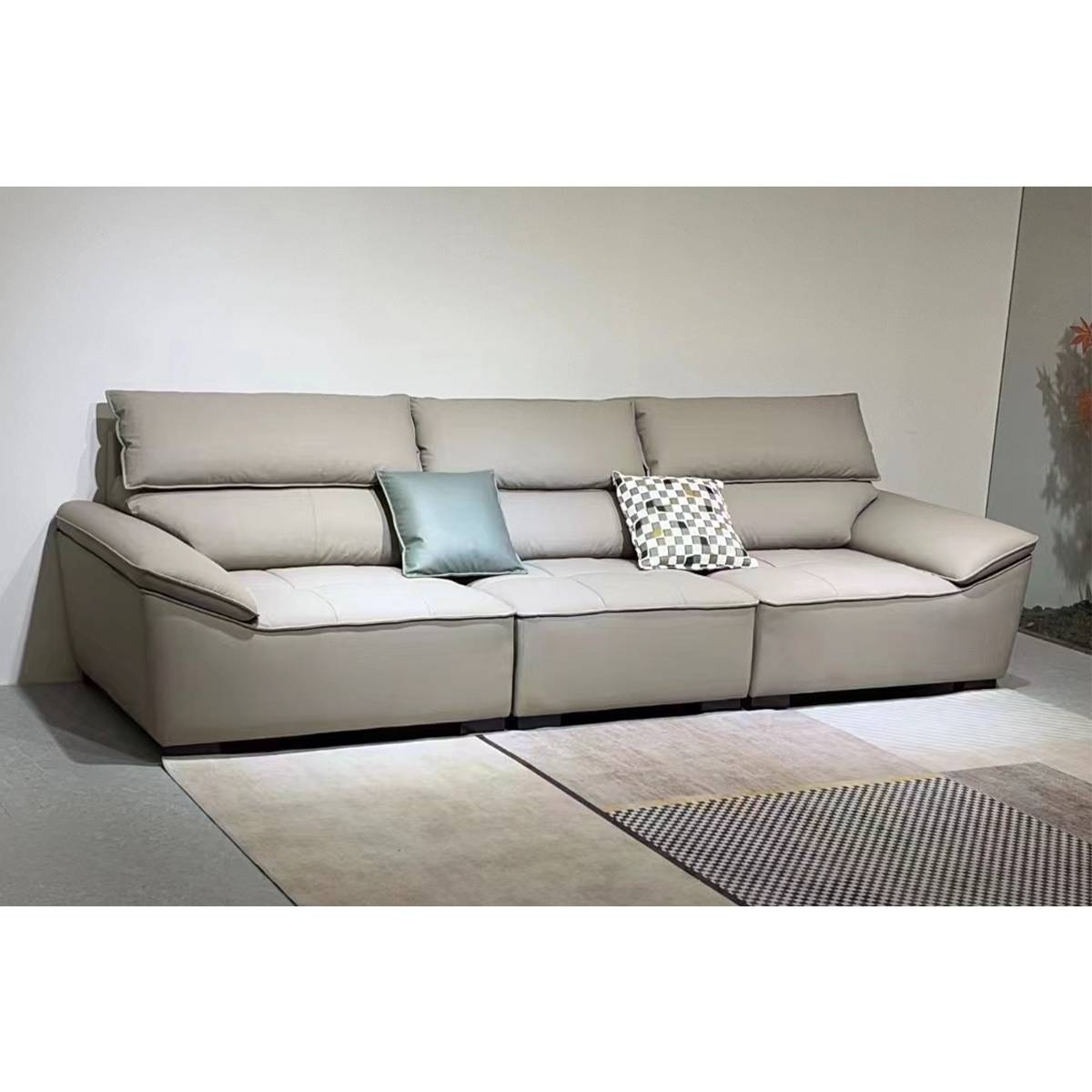 Full view of the beige sofa on a patterned rug