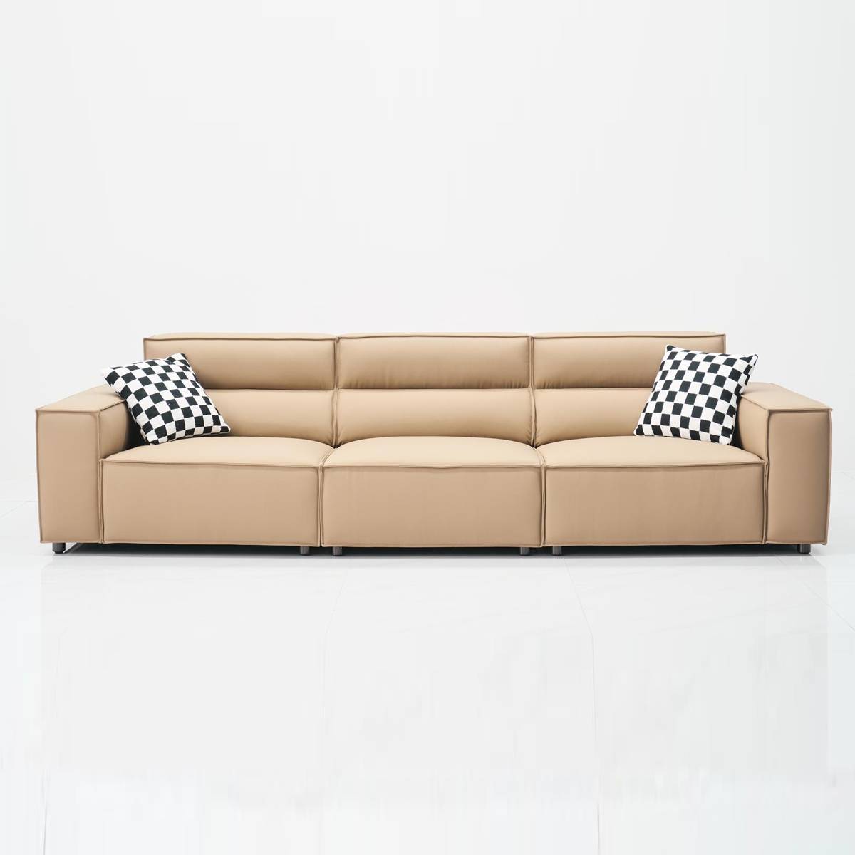 Studio shot of the sofa against a white background showing the full length and checkered pillows.