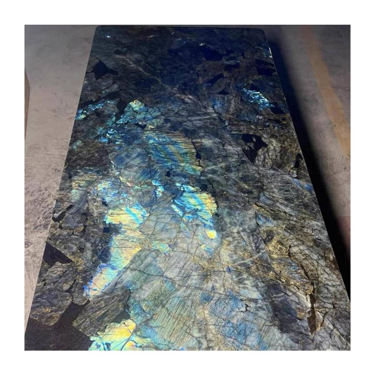 Close-up detail of the iridescent Blue Jadeite marble surface showing blue and gold patterns