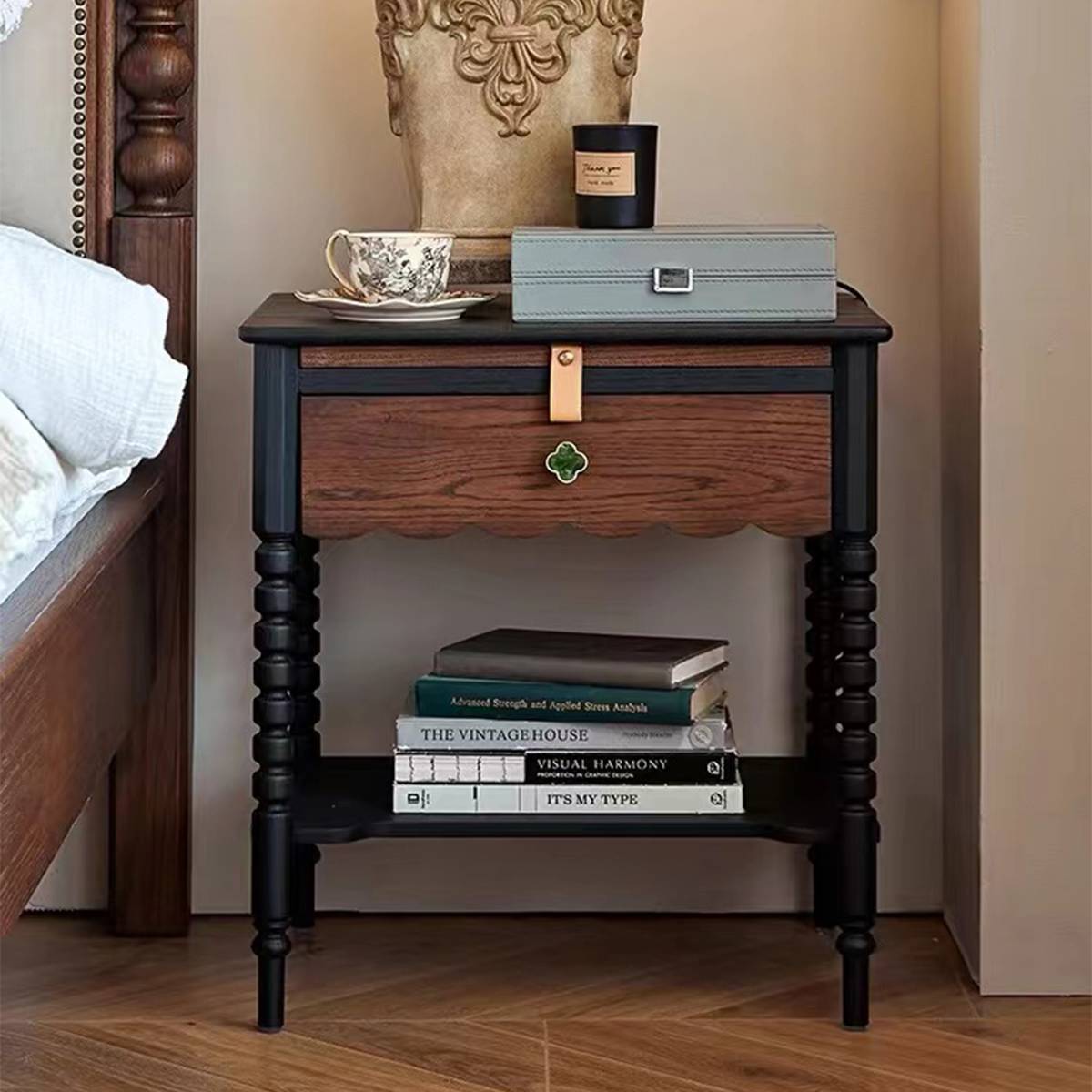 Bedside table placed next to a bed with books on the lower shelf