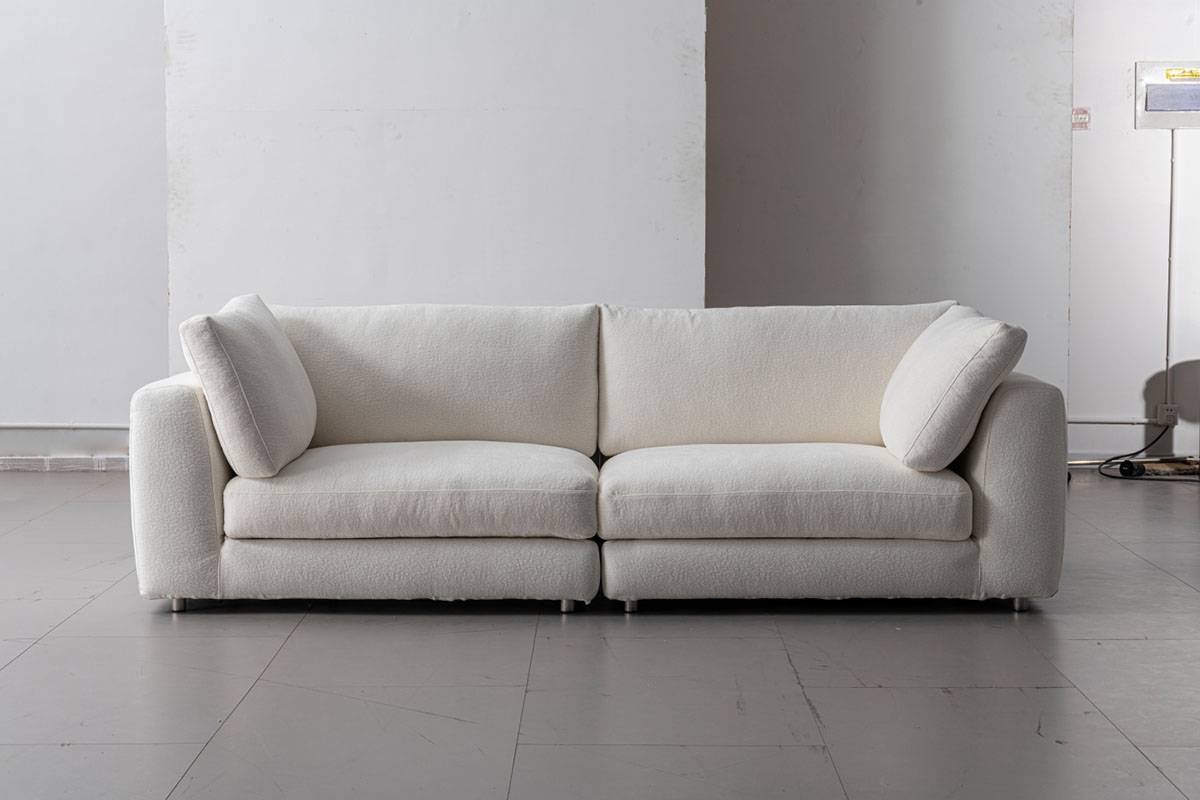 Front view of the white fabric sofa in a studio setting
