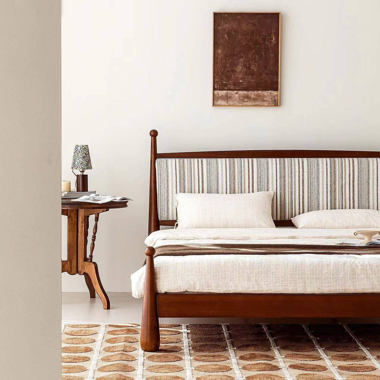 Full view of the bed with white bedding and brown throw