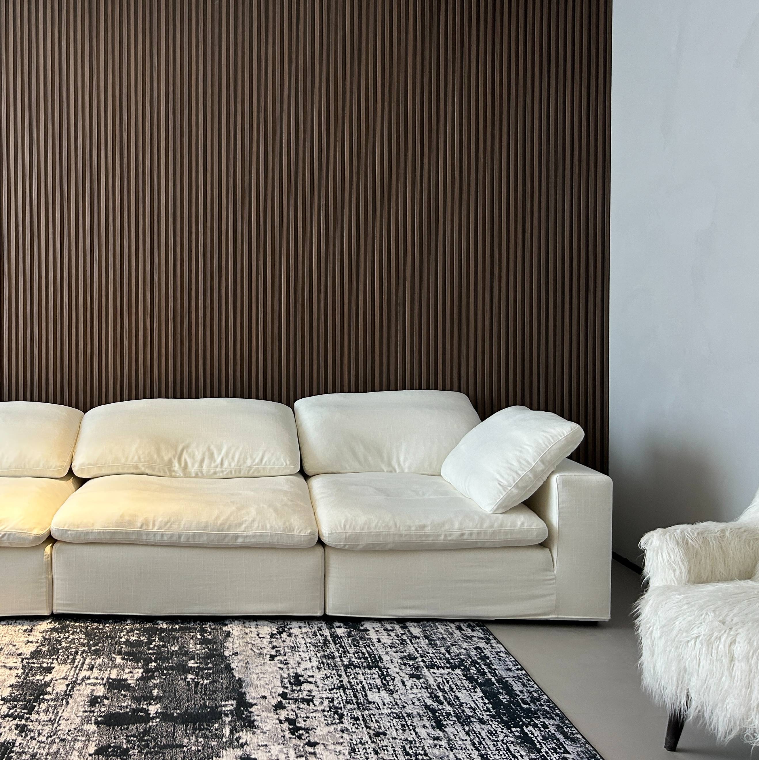 Close-up of the sofa cushions against a slatted wood wall