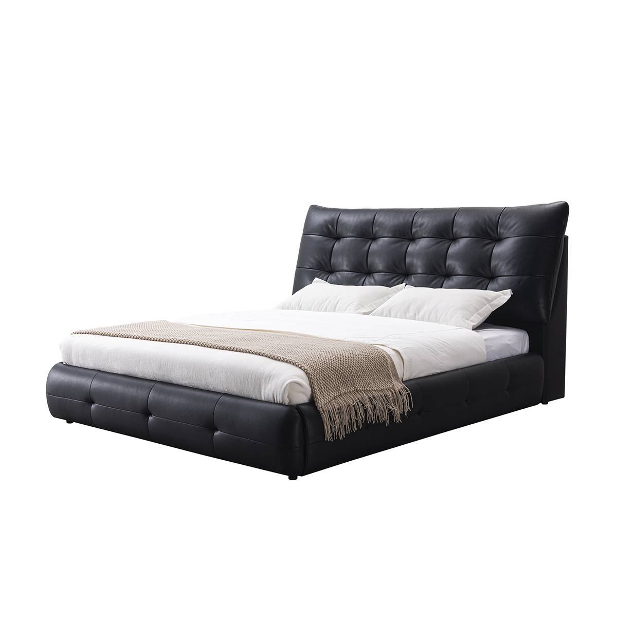 Three-quarter view of the black leather bed showing the tufted headboard and base