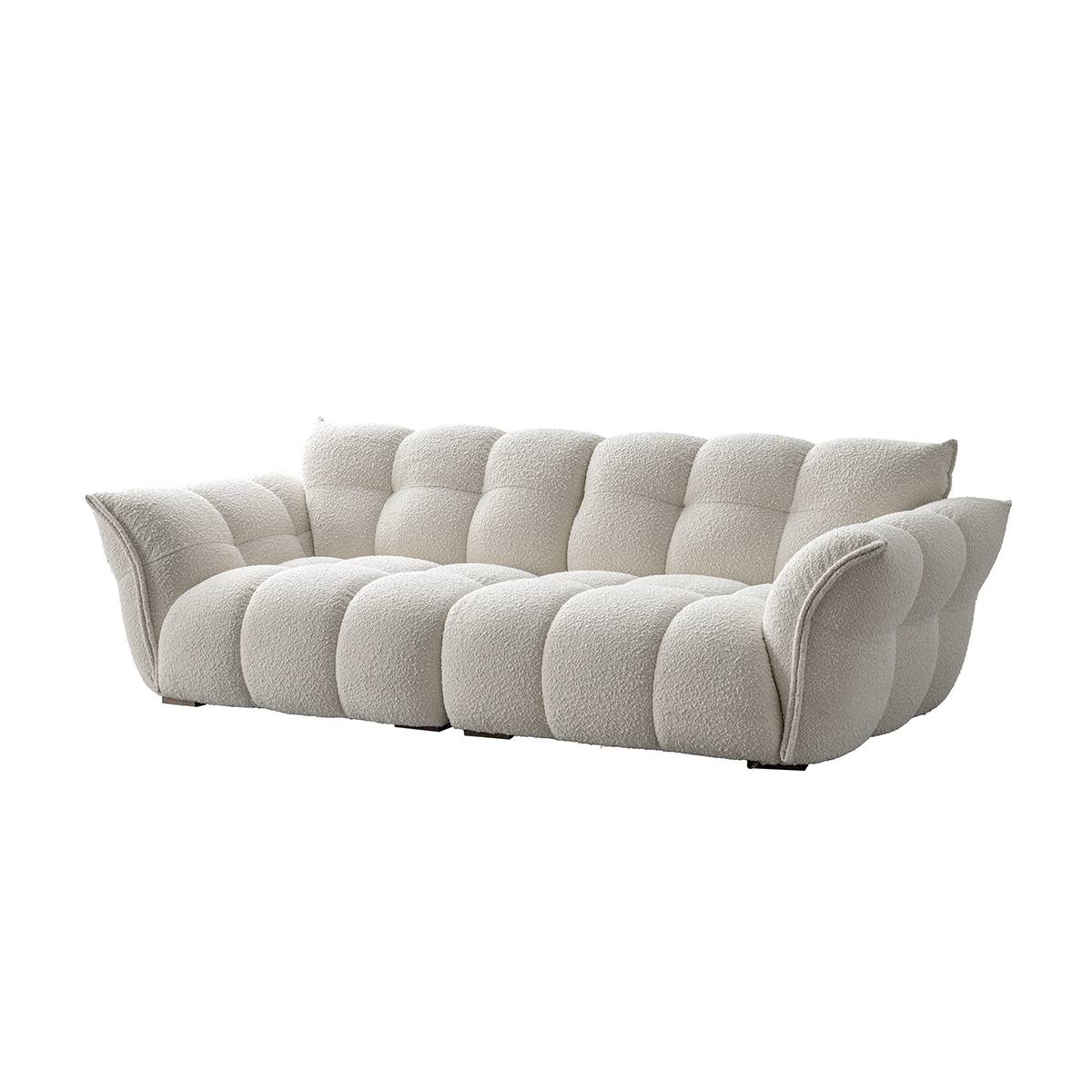 White tufted fabric sofa in a modern living room setting
