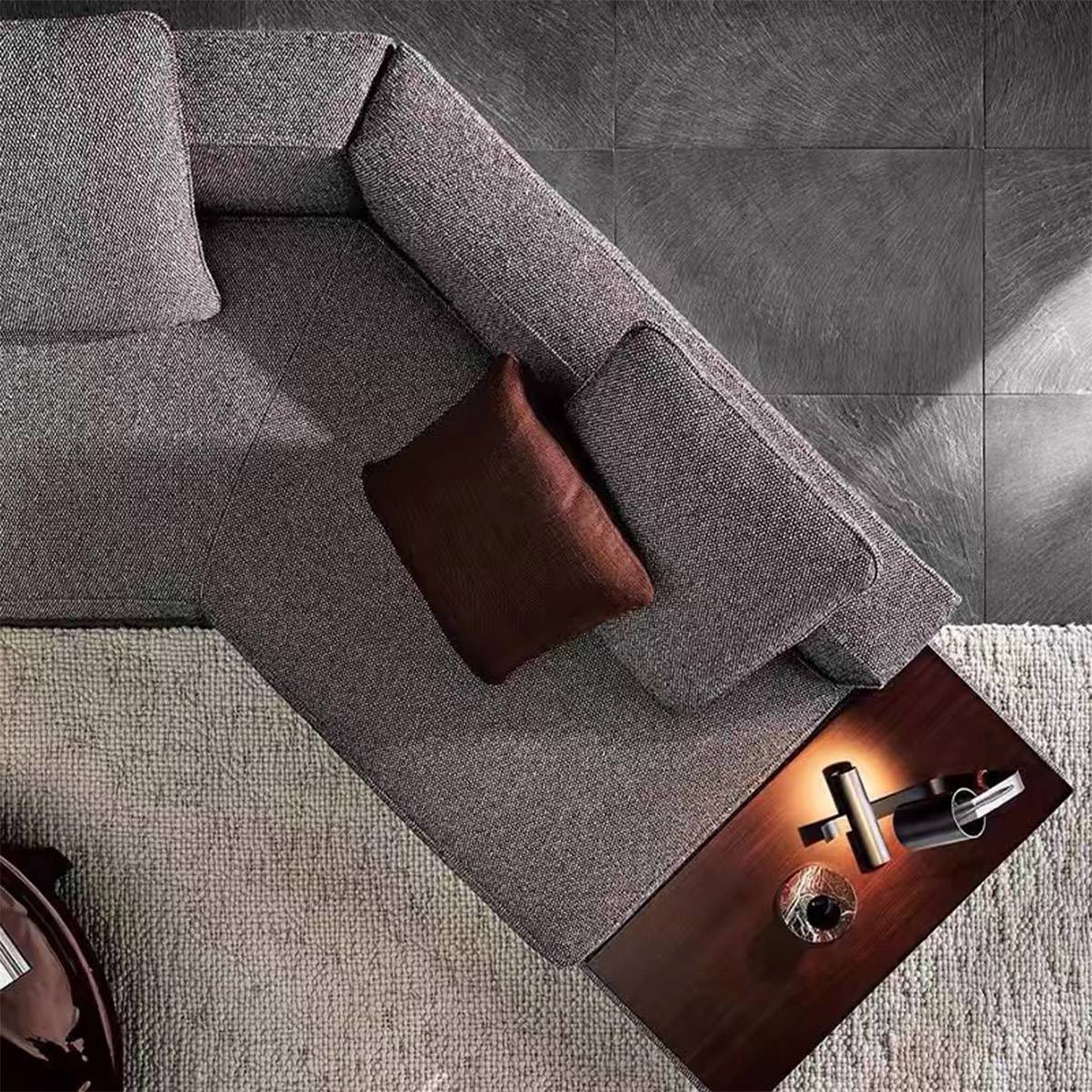 Close-up overhead view of the sofa corner, showing the brown cushion and the details of the attached wooden side table.