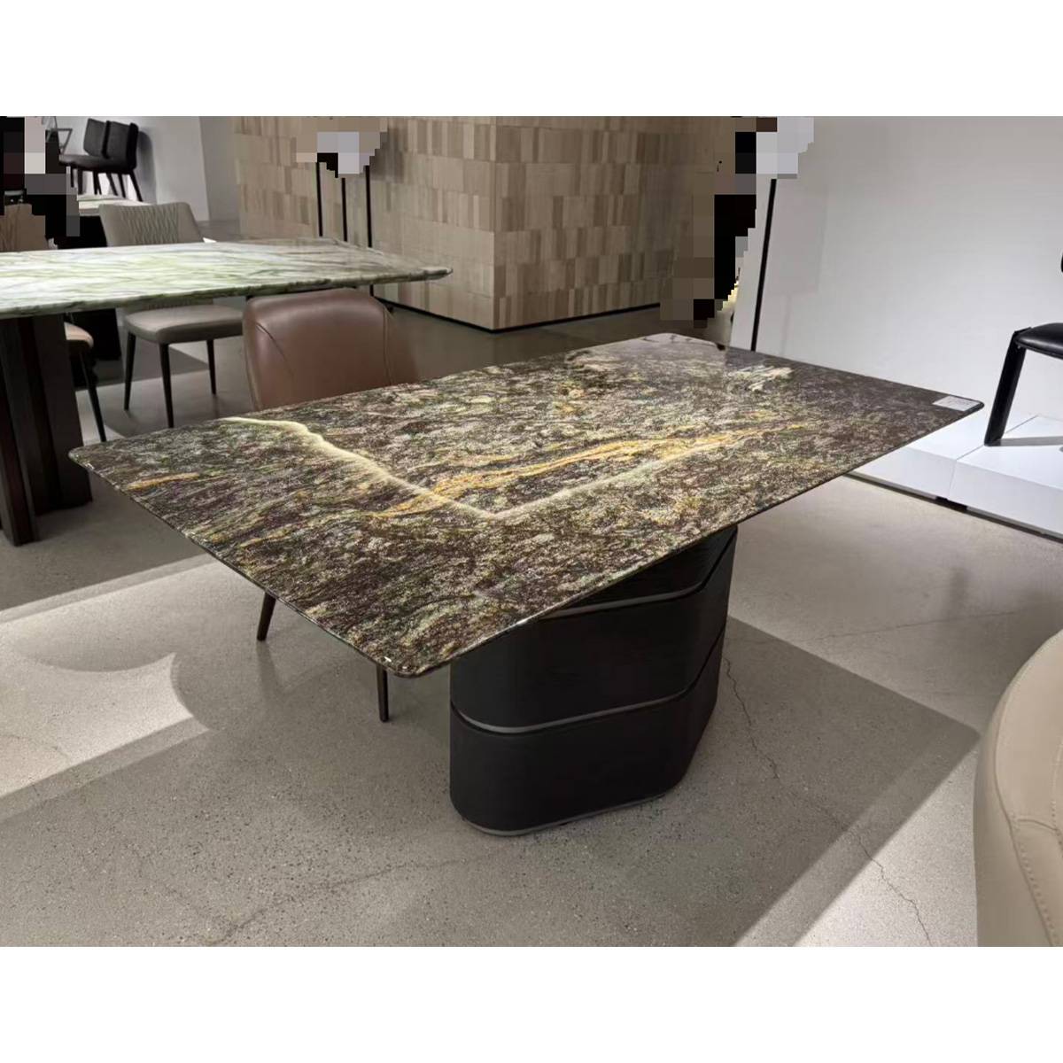 Angled view of the dining table showing the stone texture and base design.