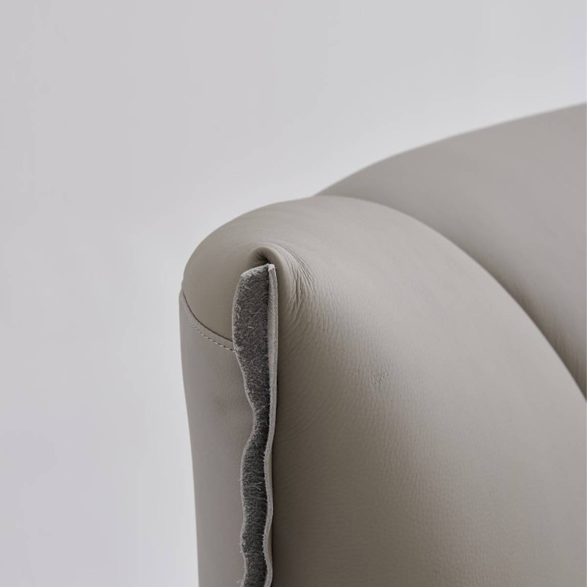 Close-up detail of the headboard corner showing leather texture and stitching