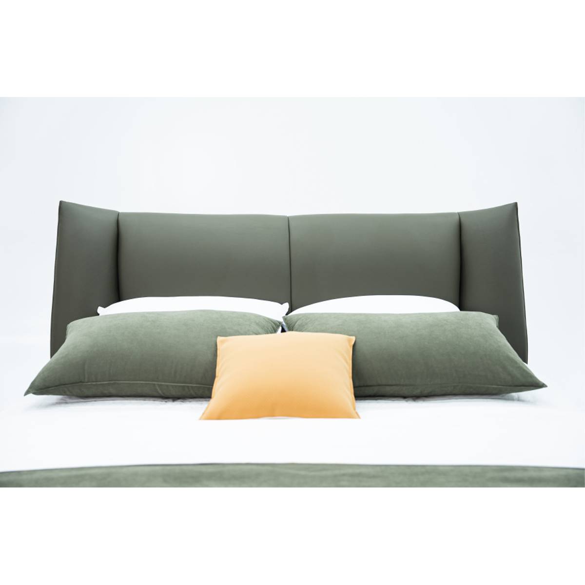 Close-up of the bed headboard and pillows showing leather texture
