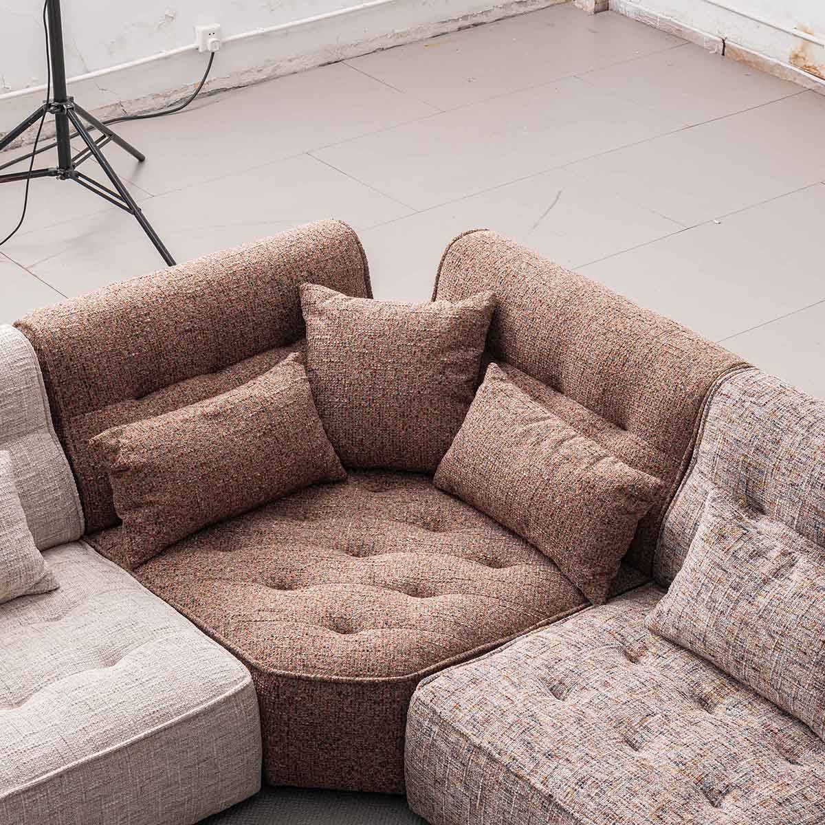 Detail shot of the sofa seat and backrest highlighting the textured fabric and button tufting