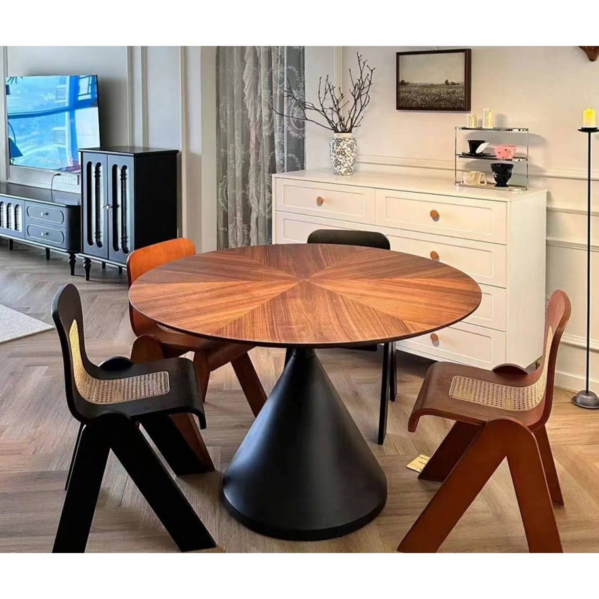 Wide shot of the dining table in a living room setting with mixed chairs