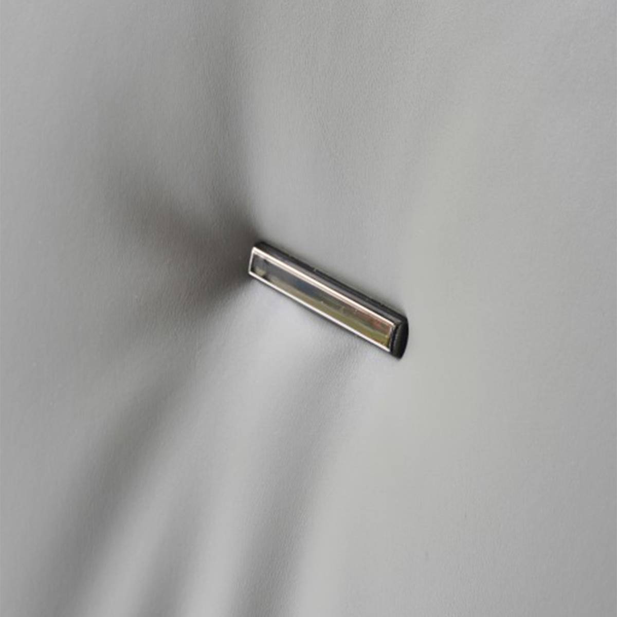 Extreme close-up of the metal accent on the chair backrest